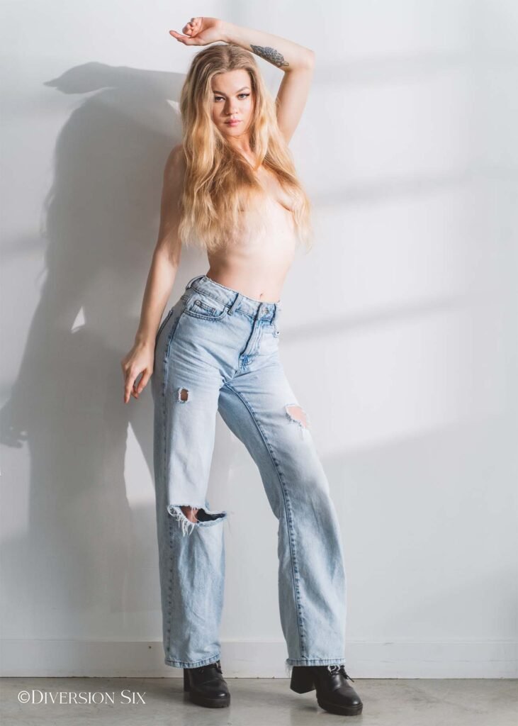 Topless blonde woman wearing jeans
