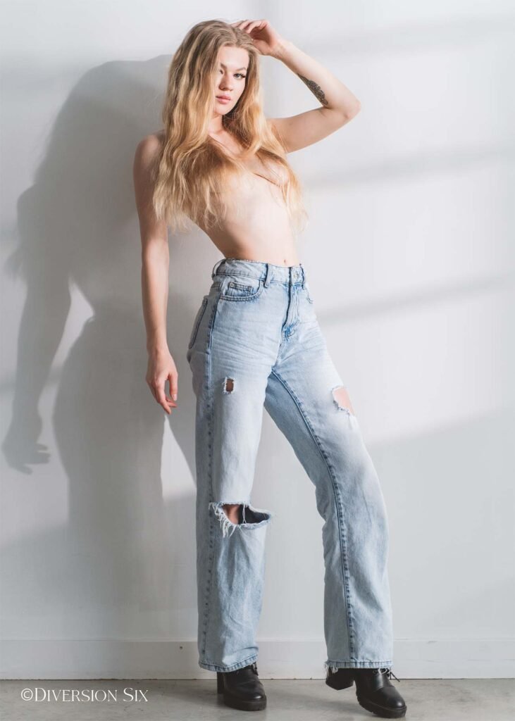 Gorgeous blonde woman topless wearing baggy jean