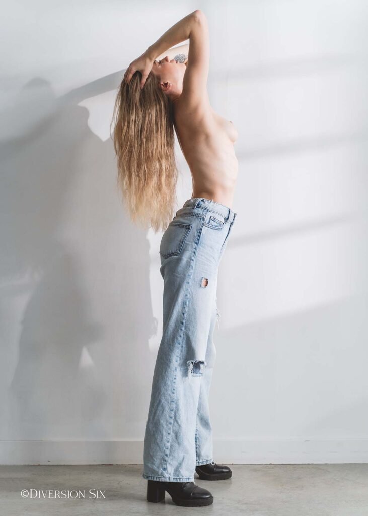 Sexy blonde model topless in denim jeans